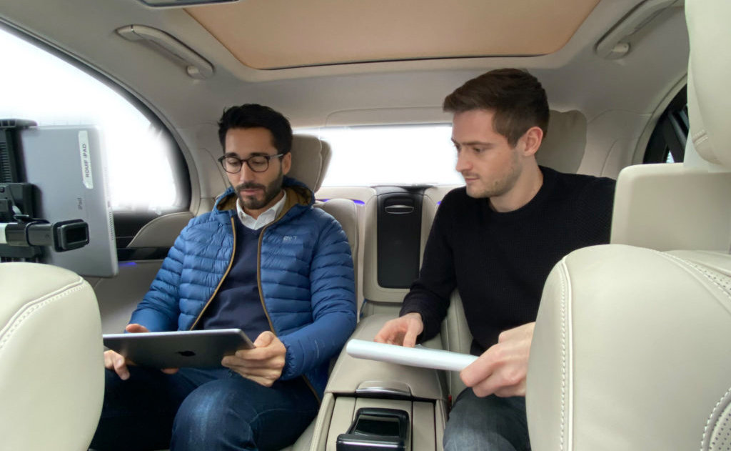 User testing session inside a Mercedes-Benz, two people with iPad and notes